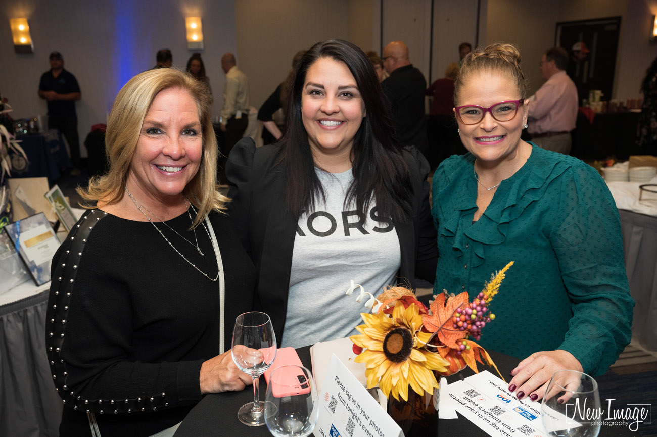 Three women standing at table at the United Way of West Central CT wine event