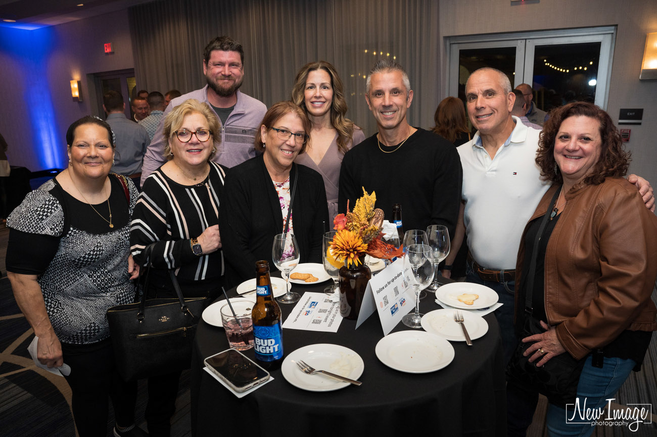 Large group of men and women standing at a table  at the United Way of West Central CT wine event