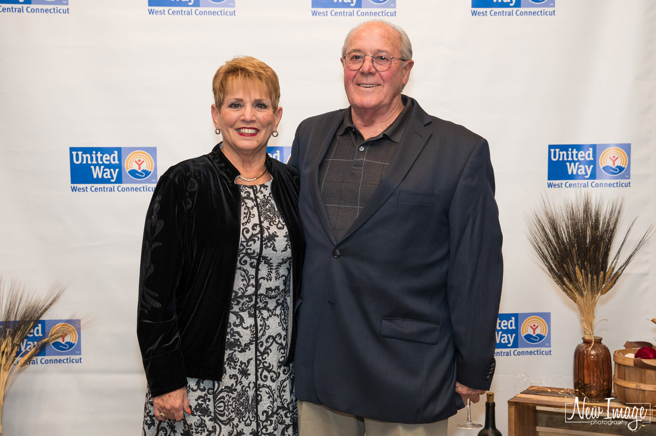 Couple posing in front of United Way of West Central banner