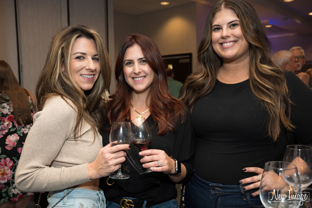 Three women with wine glasses.