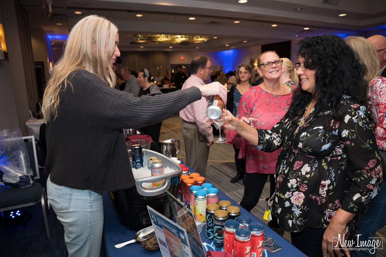 Vendor pouring wine for a guest