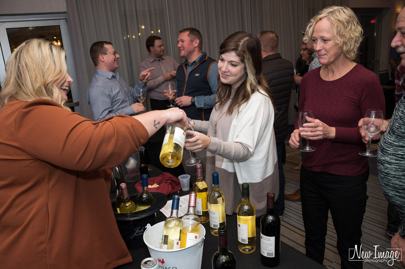 Wine vendor pouring beverage for a guest