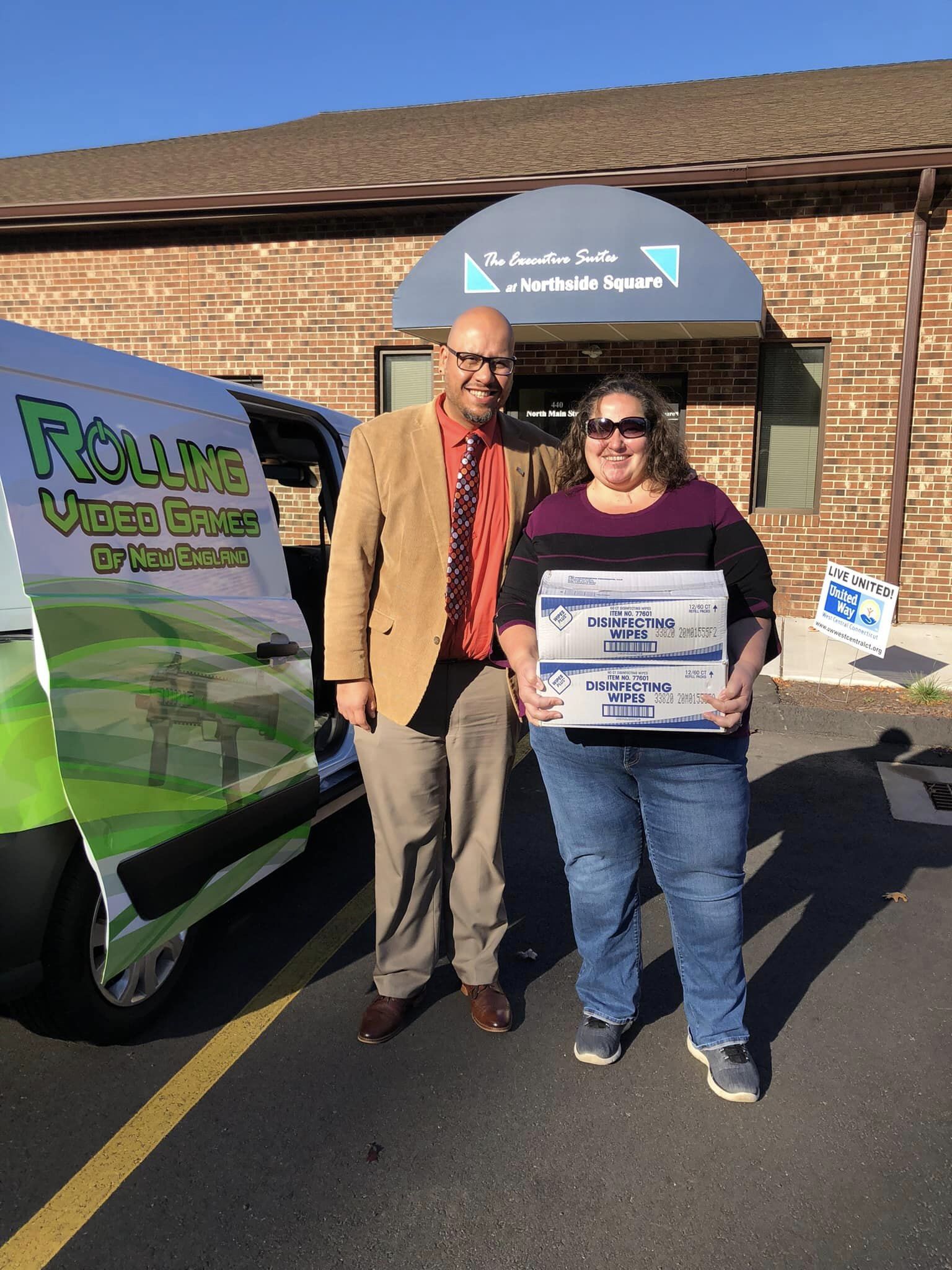 Man standing next to women dropping off a food donation