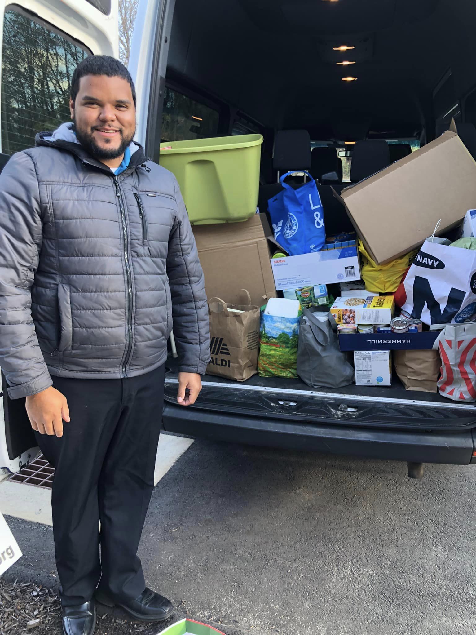 Back of van filled with a donation of canned food.