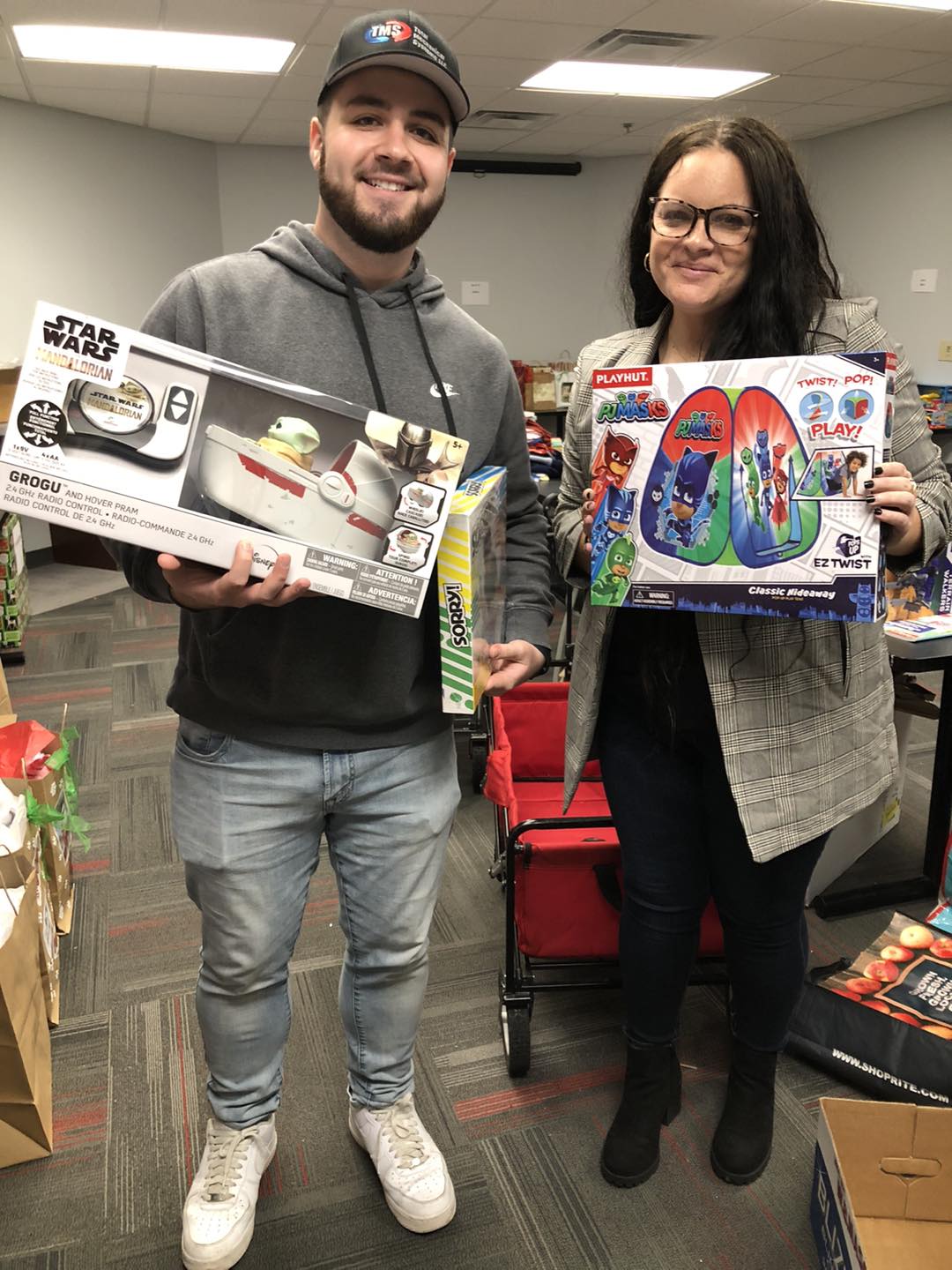 Two adults donating toys