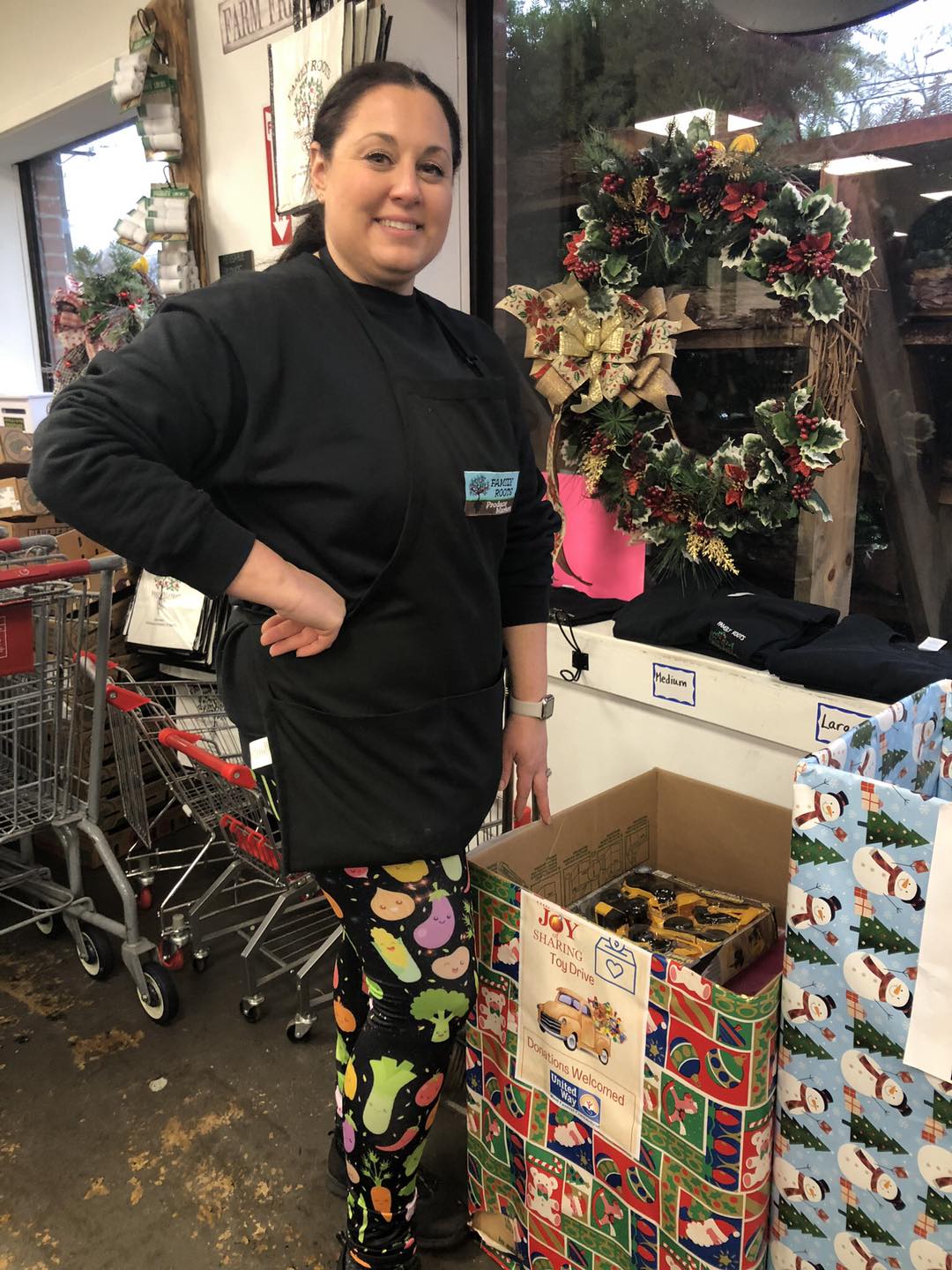 Women with full toy donation box at a store