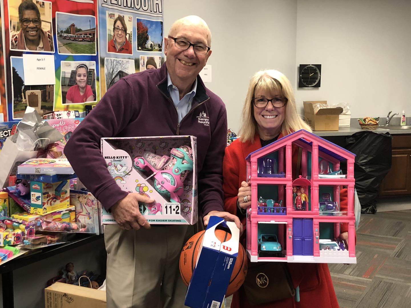 Two adults dropping off donated toys