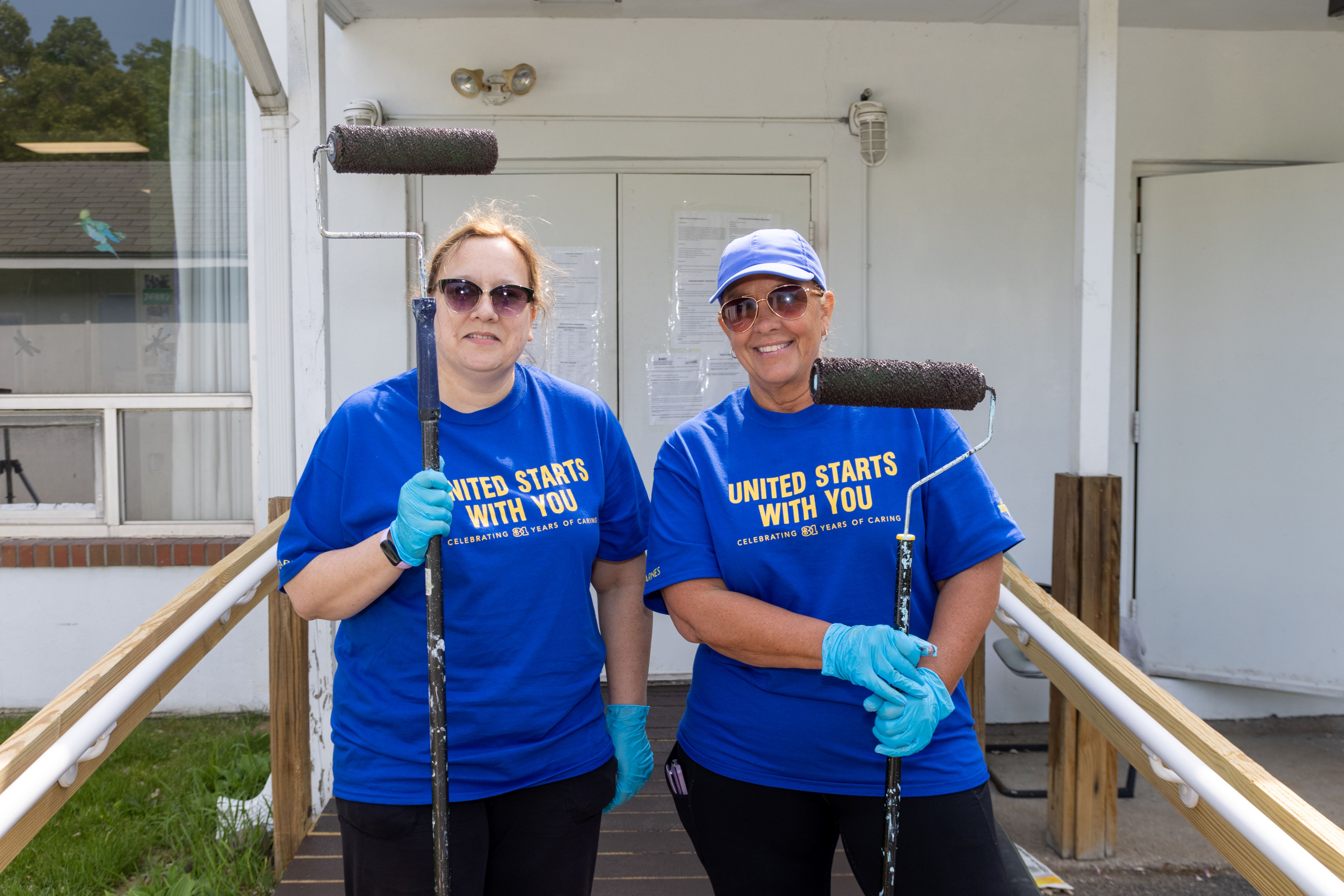 Cigna volunteers painting at Bristol Adult Resource Center.