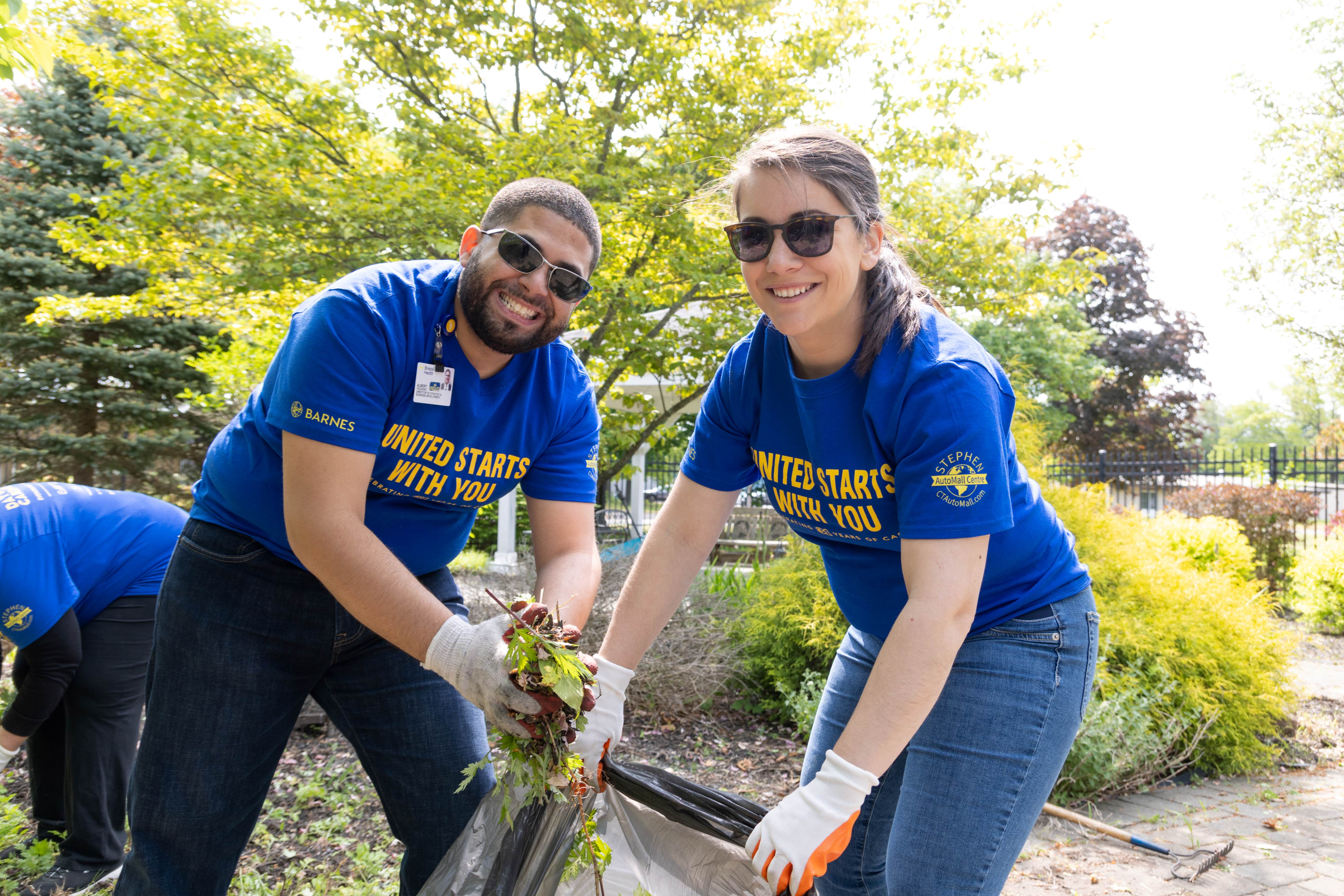 Bristol Health volunteers weeding at Bristol Adult Resource Center.