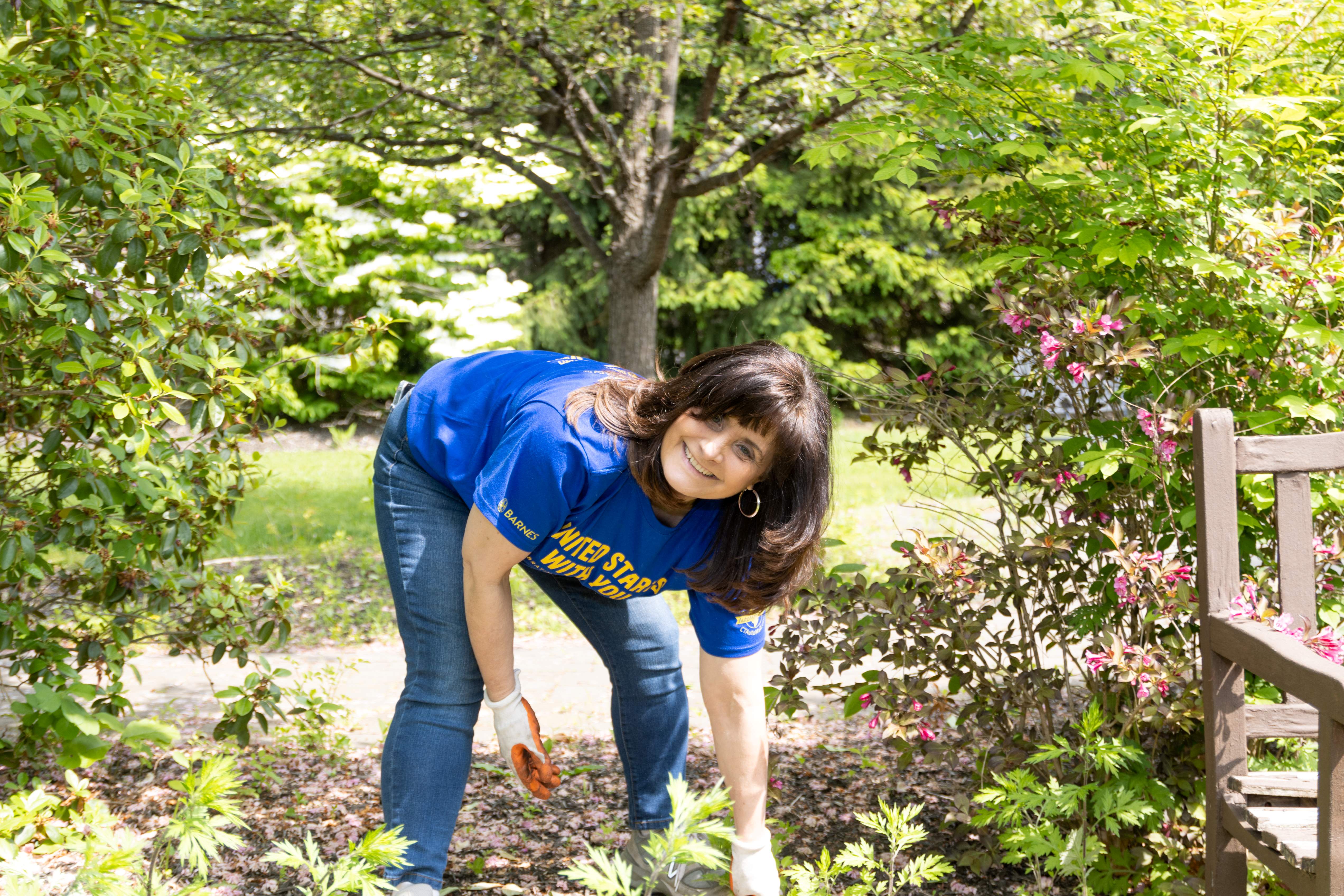 Bristol Health volunteer weeding at Bristol Adult Resource Center.